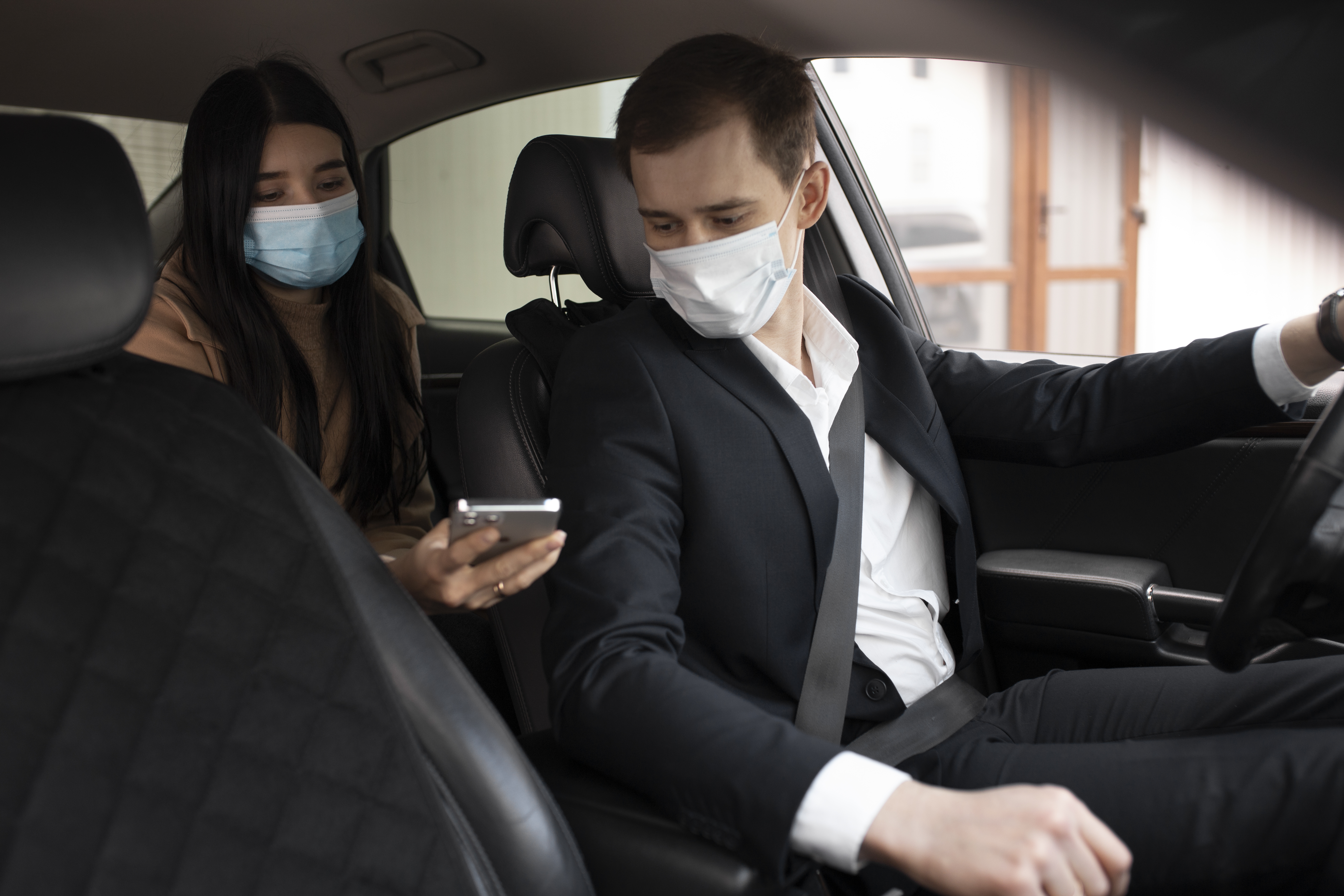 elegant taxi driver client car with medical masks